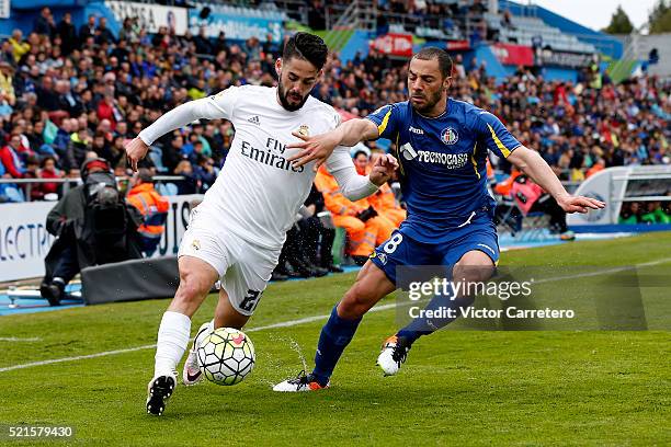 Isco Alarcon of Real Madrid competes for the ball with Mehdi Lacen of Getafe during the La Liga match between Getafe CF and Real Madrid CF at...