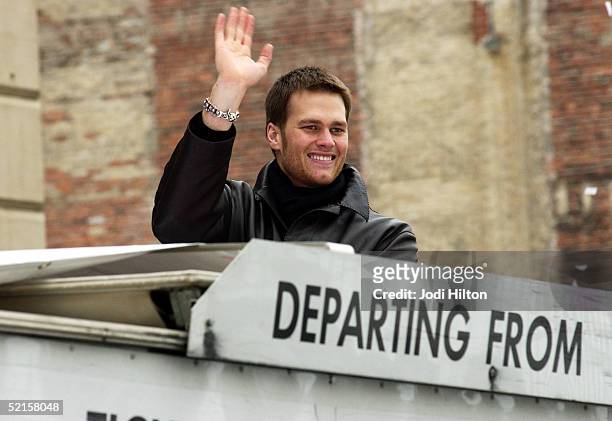 New England Patriots quarterback Tom Brady waves to crowds along Boylston Street during the team's Victory Parade February 8, 2005 in Boston,...