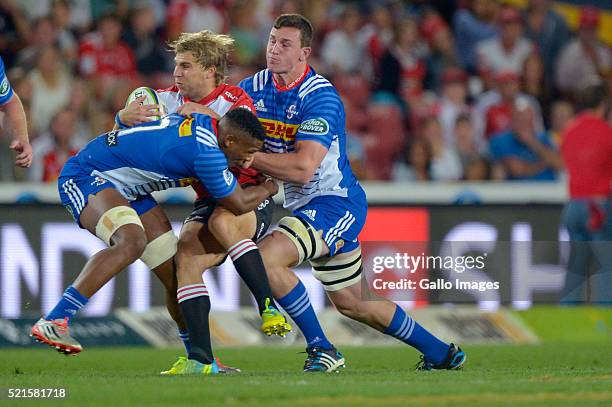 Jaco Van Der Walt of the Lions tacked by Sikhumbuzo Notshe and JD Schickerling of the Stormers during the 2016 Super Rugby match between Emirates...