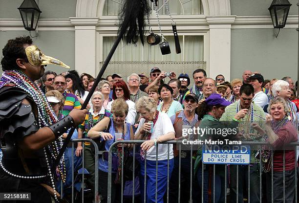 People watch the Bourbon Street Awards for costume design during Mardi Gras festivities February 8, 2005 in New Orleans, Louisiana. Mardi Gras is the...