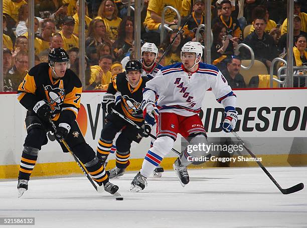 Evgeni Malkin of the Pittsburgh Penguins moves the puck in front of Dylan McIlrath of the New York Rangers in Game Two of the Eastern Conference...