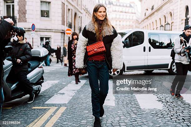 Danish model Caroline Brasch Nielsen wears a Sandy Liang coat and red Chanel bag after the Balmain show at Hotel Potocki on Day 3 of PFW FW16 on...