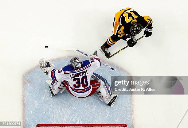 Henrik Lundqvist of the New York Rangers makes a save on Bryan Rust of the Pittsburgh Penguins in Game Two of the Eastern Conference Quarterfinals...