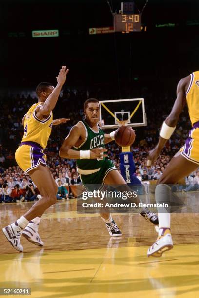 Dennis Johnson of the Boston Celtics drives to the basket against the Los Angeles Lakers during an NBA game in 1989 at the Great Western Forum in...