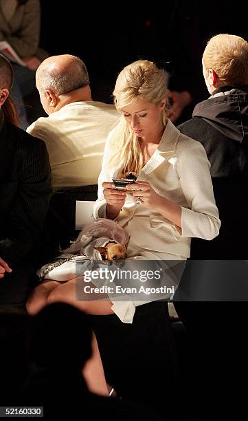 Paris Hilton uses her cell phone while attending the Narciso Rodriguez Fall 2005 show during Olympus Fashion Week at Bryant Park February 8, 2005 in...