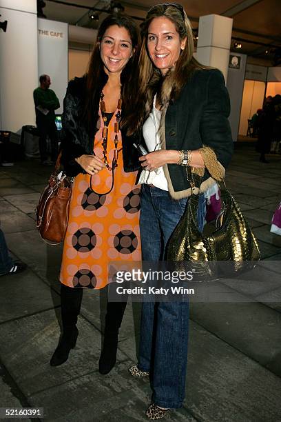 Regina Hanes from Marie Claire and Karen Haines from Cosmo pose for photos in the lobby of the main tent during Olympus Fashion Week Fall 2005 at...