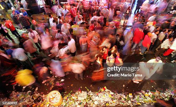 Revelers walk on Bourbon Street during Mardi Gras festivities February 8, 2005 in New Orleans, Louisiana. Mardi Gras is the last carnival celebration...