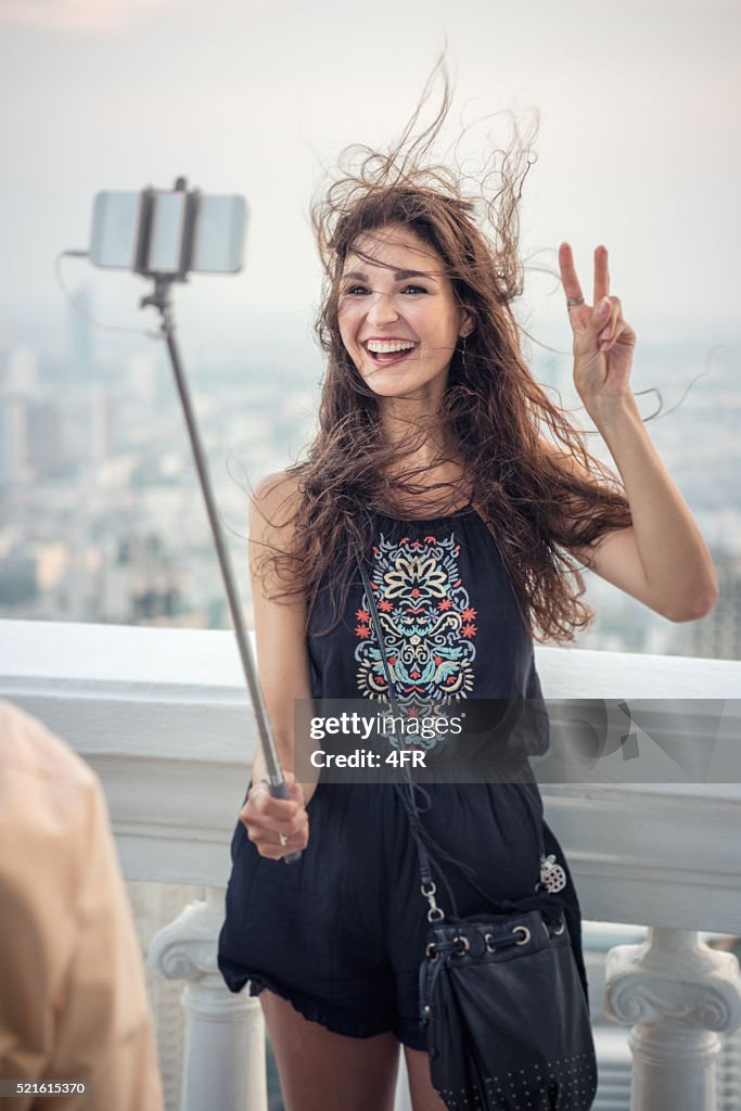 Woman taking a Selfie with a Selfie Stick on Vacation