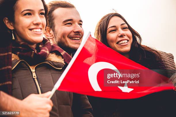 happy friends during a demonstration - turk flag stock pictures, royalty-free photos & images