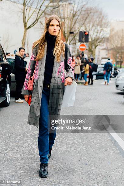 Danish model Caroline Brasch Nielsen wears a gray Dries Van Noten plaid coat with pink floral embroidery and jeans after the Celine show at Tennis...