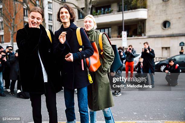 Models Laura Kampman, Marte Mei Van Haaster, and Maggie Maurer carry Celine twisted cabas bags after the Celine show at Tennis Club de Paris on Day 6...