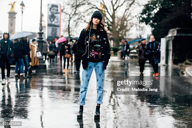 Model Ana Cristina wears customized vintage Bowsdontcry from Noir Kennedy sequin sweater and jeans with illustrations after the Leonard Paris show at...