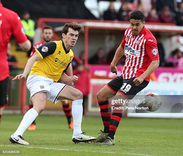 John Marquis of Northampton Town plays the ball under pressure from Troy Brown of Exeter City during the Sky Bet League Two match between Exeter City...