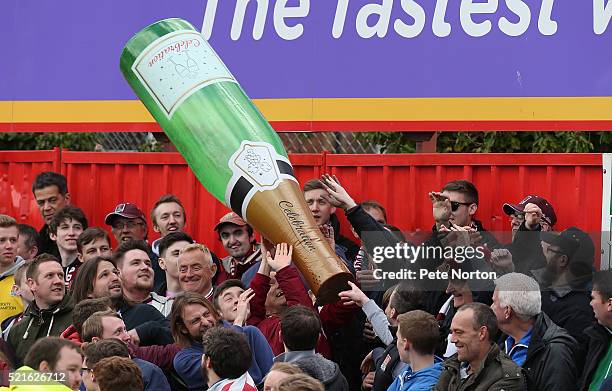 Northampton Town fans with a large inflatable champagne bottle prior to the Sky Bet League Two match between Exeter City and Northampton Town at St...