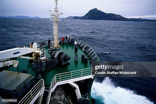 ecotourists looking at cape horn aboard akademik ioffe - straat drake stockfoto's en -beelden