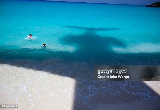 shadow of landing airplane over beach - jake warga stock pictures, royalty-free photos & images
