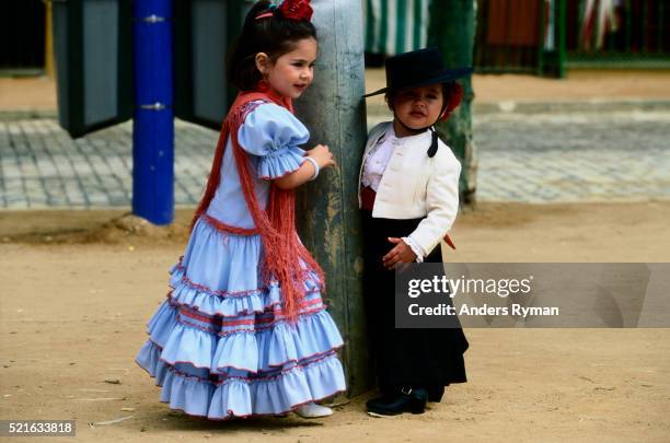 two girls in traditional andalucian dress - feria de abril stock pictures, royalty-free photos & images