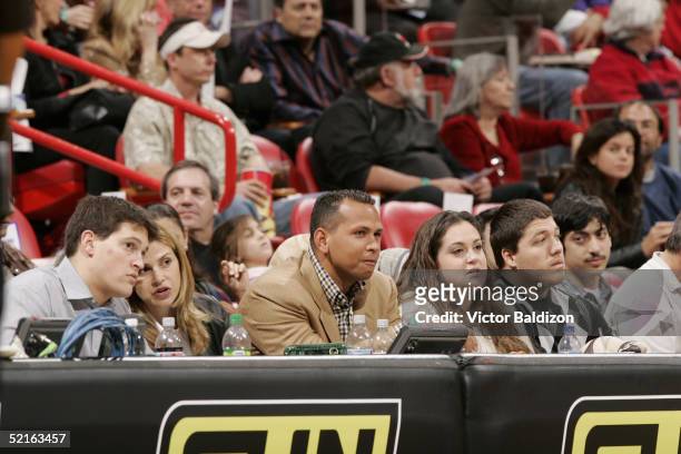 Infielder Alex Rodriguez of the New York Yankees watches the game between the New Orleans Hornets and the Miami Heat at American Airlines Arena on...