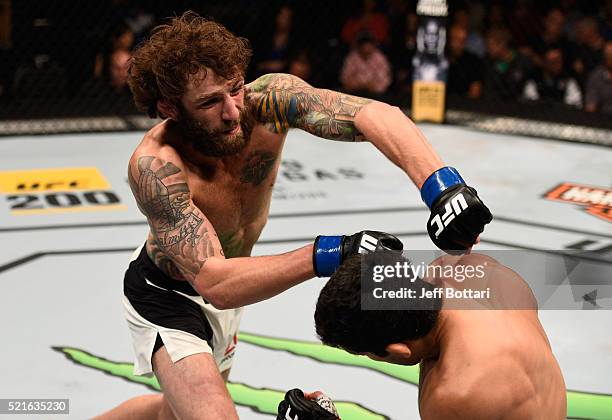 Michael Chiesa punches Beneil Dariush in their lightweight bout during the UFC Fight Night event at Amalie Arena on April 16, 2016 in Tampa, Florida.