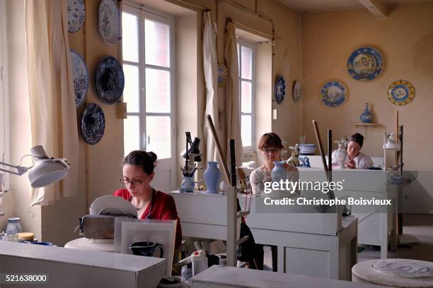 painting traditional nevers earthenware at montagnon earthenware factory - earthenware stock pictures, royalty-free photos & images