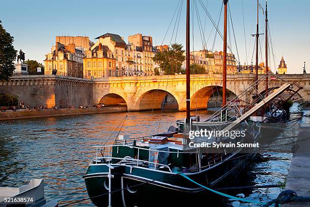 sailboats moored at quai de conti near pont neuf - river seine foto e immagini stock