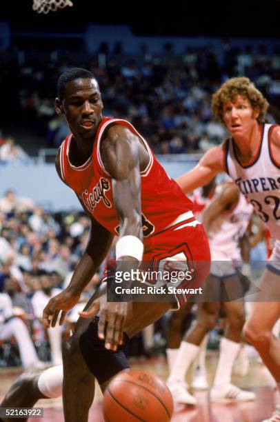 Michael Jordan of the Chicago Bulls moves the ball against Bill Walton of the Los Angeles Clippers during a December 1984 season game at the Sports...