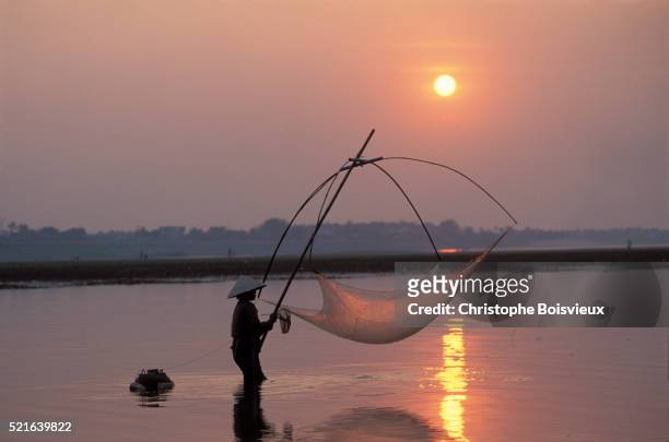 fishing at sunset on the mekong river - river mekong stock pictures, royalty-free photos & images