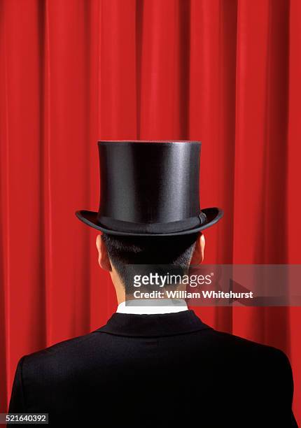 man in top hat facing red curtain - シルクハット ストックフォトと画像