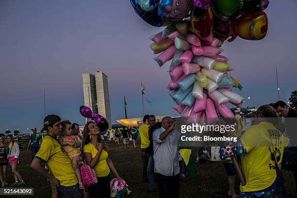 Street vendor sells cotton candy and balloons to protesters during a demonstration against Dilma Rousseff, Brazil's president, outside Congress in...