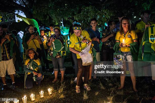 Protesters hold a candle light vigil during a demonstration against Dilma Rousseff, Brazil's president, outside Congress in Brasilia, Brazil, on...