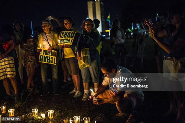 Protesters hold a candle light vigil during a demonstration against Dilma Rousseff, Brazil's president, outside Congress in Brasilia, Brazil, on...