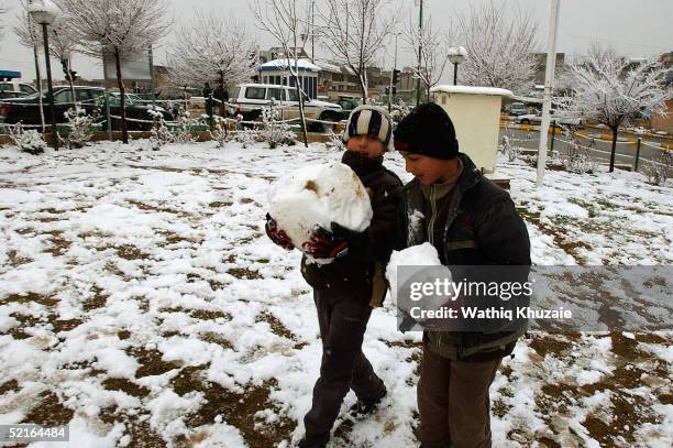 Iraqi Kurdish children play in the snow February 9, 2005 in the northern Iraqi city of Suleimaniya, Iraq. The announcement of the final results of...