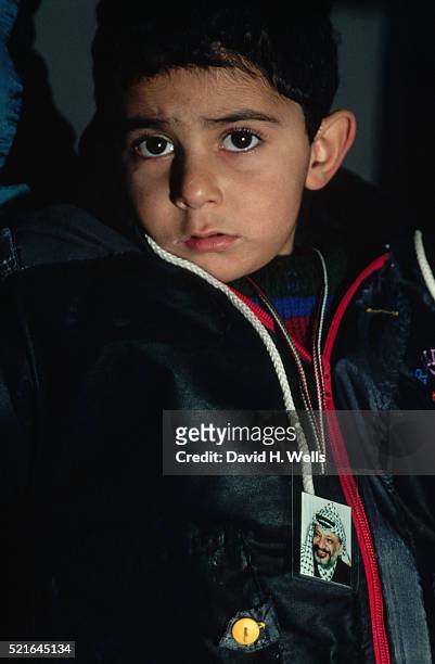 palestinian boy wears yasir arafat photo - palestinian boy stock pictures, royalty-free photos & images