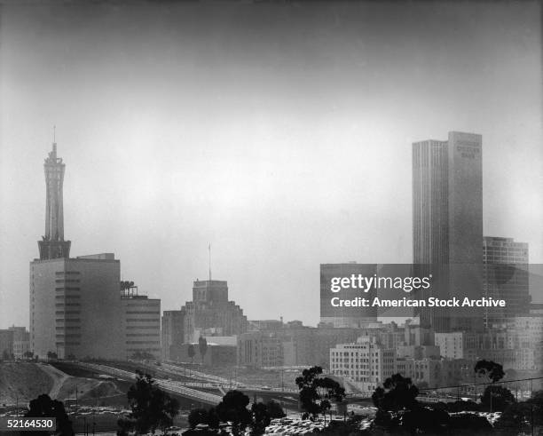 Photo shows the skyline of downtown Los Angeles including the PacBell building , One Bunker Hill , the City National Bank building , the Crocker...