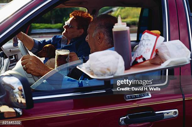 couple at a drive-in a&w restaurant - drinking soda in car stock pictures, royalty-free photos & images