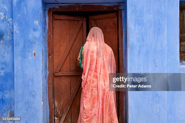 woman in doorway in jaisalmer - jaisalmer stock pictures, royalty-free photos & images