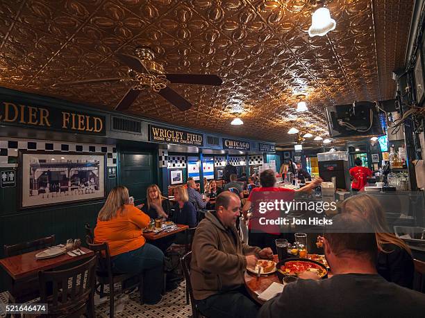 interior of a chicago pizzeria. - deep dish pizza stock pictures, royalty-free photos & images