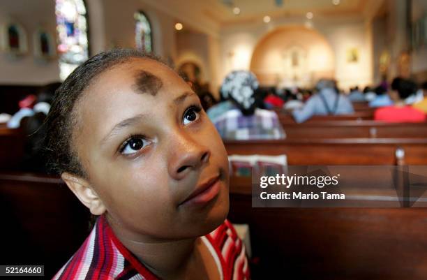 Ashley Wagner wears a cross of ashes on her forehead prior to Ash Wednesday services at St. Jude's Church the day after Mardi Gras festivities...