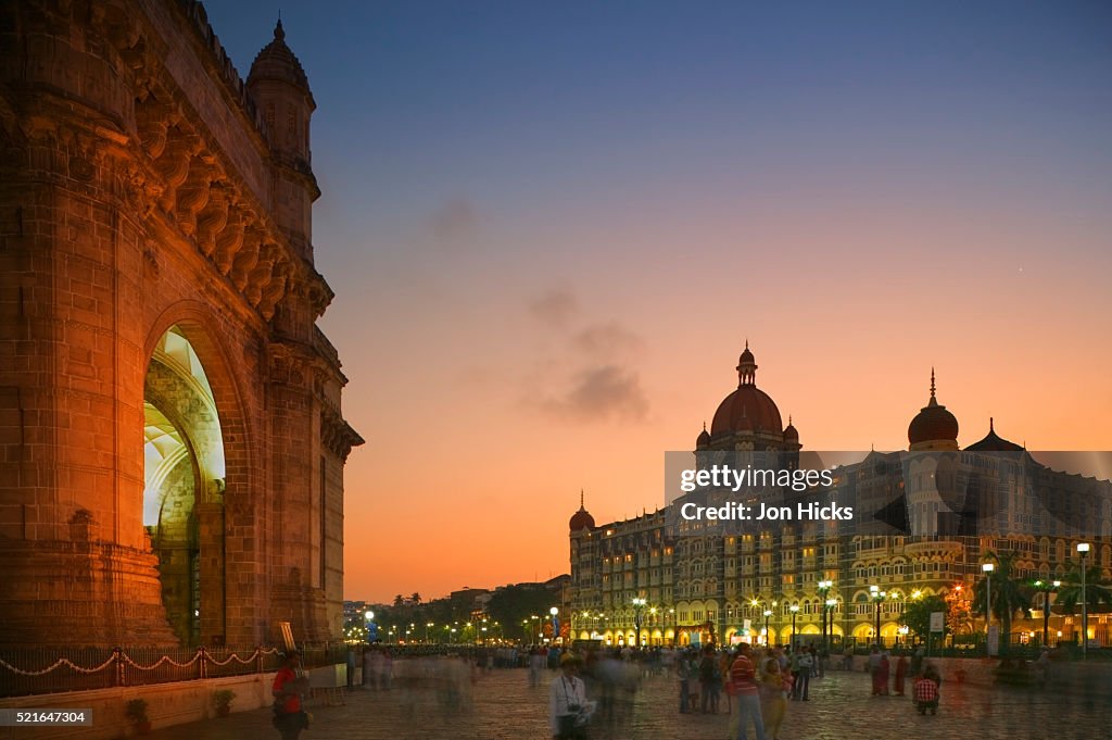 People Strolling Between the Gateway of India and the Taj Mahal Palace Hotel