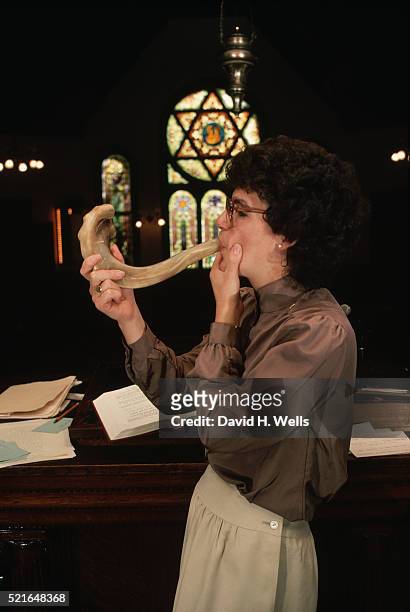 female rabbi blowing shofar - shofar stock pictures, royalty-free photos & images