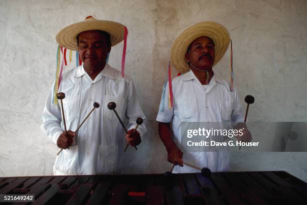 hispanic musicians performing on marimbas - marimba stock pictures, royalty-free photos & images