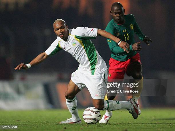 El Hadji Diouf of Senegal is tackled by Achile Emana of Cameroon during the International friendly match between Cameron and Senagal at Stade...