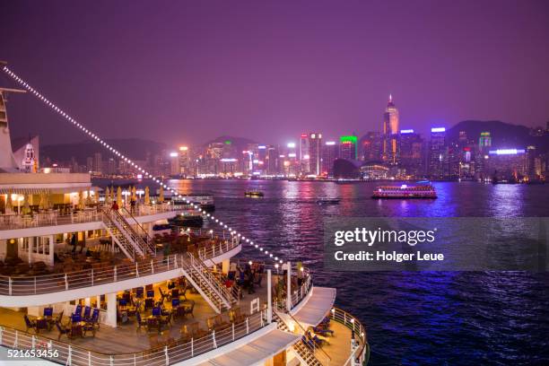 cruise ship ms deutschland (reederei peter deilmann) at ocean terminal with skyline across harbor - ms deutschland cruise ship stock pictures, royalty-free photos & images