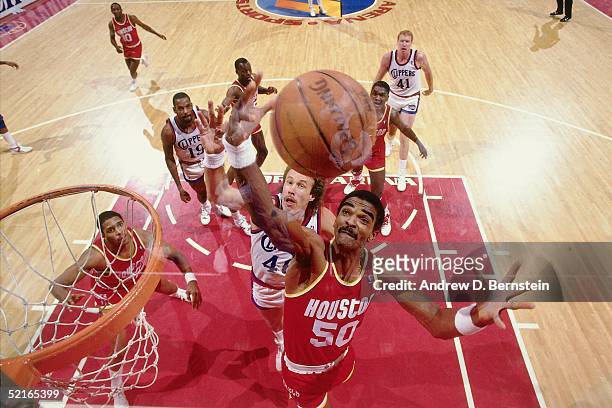 Ralph Sampson of the Houston Rockets goes up for a rebound against the Los Angeles Clippers during an NBA game at the Los Angeles Memorial Sports...