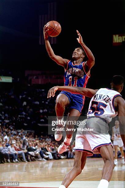 Isiah Thomas of the Detroit Pistons drives to the basket for a layup against the Washington Bullets during an NBA game circa 1991 at the Capital...