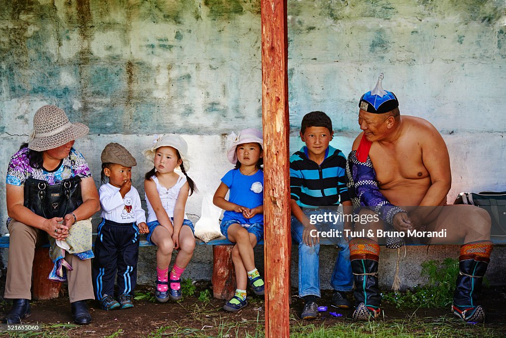 Mongolia, Arkhangai province, Bulgan, the Naadam festival, children with a wrestler
