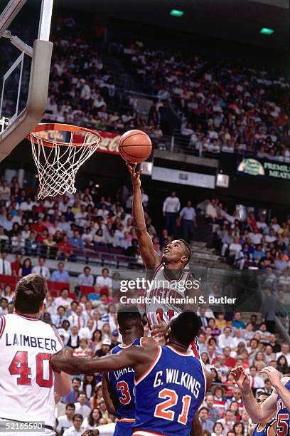 Isiah Thomas of the Detroit Pistons drives to the basket for a layup against the New York Knicks during an NBA game circa 1989 at The Palace in...