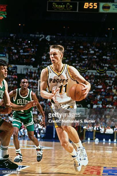 Detlef Schrempf of the Indiana Pacers drives to the basket against the Boston Celtics during an NBA game at Market Square Arena circa 1990 in...