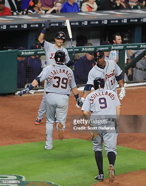 Jarrod Saltalamacchia of the Detroit Tigers is greeted by teammates after Saltalamacchia hit a two-run home run in the sixth inning of their game...