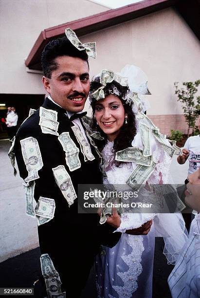 bride and groom covered in money - st helena ethnicity stock pictures, royalty-free photos & images